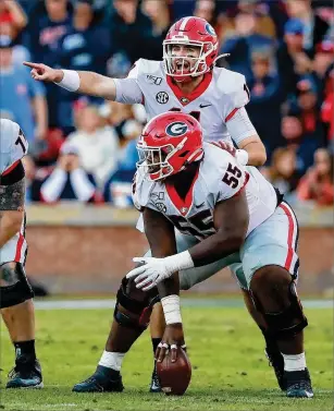 ?? CURTIS COMPTON / CCOMPTON@AJC.COM ?? Quarterbac­k Jake Fromm calls an audible against Auburn last month. Georgia’s offense is efficient, but the main problems have been finishing drives with touchdowns (ranked 10th in red-zone touchdown percentage in SEC games) and creating big plays.