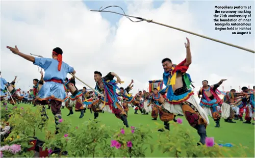  ??  ?? Mongolians perform at the ceremony marking the 70th anniversar­y of the foundation of Inner Mongolia Autonomous Region held in Hohhot on August 8