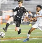  ?? STEVE RUARK/BALTIMORE SUN MEDIA GROUP ?? Mount Hebron’s Liam McCaffery, left, and Oakland Mills’ JoJo Ocran vie for a ball in the first half of a high school soccer match.