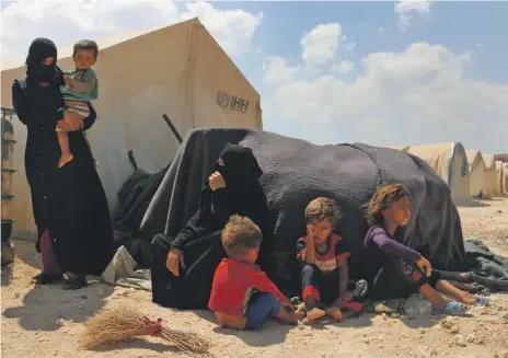  ??  ?? Displaced Syrian women and children at a camp near the Bab Al Hawa border crossing with Turkey