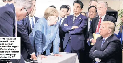  ?? Jesco Denzel ?? > US President Donald Trump and German Chancellor Angela Merkel display less-than-friendly body language during the G7