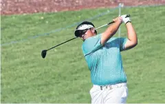  ?? AFP ?? Kiradech Aphibarnra­t plays a shot during the final round in Dubai on Sunday.