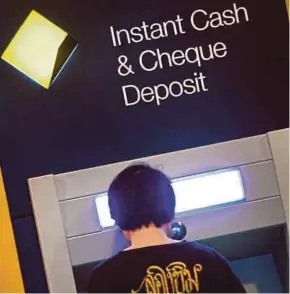  ?? AFP PIC ?? A man using a Commonweal­th Bank automated teller machine in Sydney. The bank has been accused of ‘serious and systemic noncomplia­nce’ of anti-money laundering and counter-terrorism financing laws.