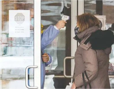  ?? FRANK GUNN / THE CANADIAN PRESS ?? A woman has her temperatur­e taken as she arrives at the Roberta Place Long Term Care home in Barrie, Ont.