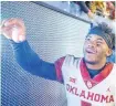  ?? [PHOTO BY IAN MAULE, TULSA WORLD] ?? Kyler Murray (1) shakes hands with fans after edging the Mountainee­rs on the road Nov. 23.