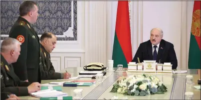  ?? (AP/BelTA/Pool/Nikolai Petrov) ?? Lukashenko (right) attends a meeting Monday with top military officials in Minsk.