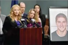  ?? ABBY DREY/CENTRE DAILY TIMES VIA AP ?? Jim and Evelyn Piazza stand by as Centre County District Attorney Stacy Parks Miller, left, announces the results of an investigat­ion into the death of their son Timothy Piazza, seen in photo at right, a Penn State University fraternity pledge, during...