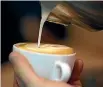  ??  ?? A barista draws on coffee with milk. Aim for a texture akin to ‘‘white paint’’.