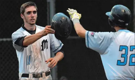  ?? DANA JENSEN/THE DAY ?? Ben Ruta, left, of the Mystic Schooners receives a high five from teammate Lou Iannotti after scoring a run during an NECBL baseball game Tuesday against the New Bedford Bay Sox. Ruta has started all but two games for the Schooners this summer.