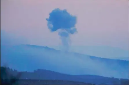  ?? LEFTERIS PITARAKIS — THE ASSOCIATED PRESS ?? Plumes of smoke rise from inside Syria on Saturday as seen from the outskirts of the border town of Kilis, Turkey. Turkish jets began an aerial offensive called Operation Olive Branch against the Syrian Kurdish-held enclave of Afrin.