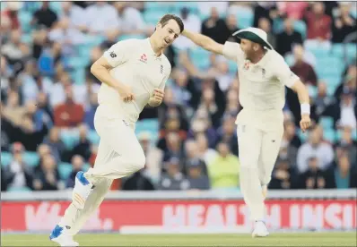  ??  ?? England’s Toby Roland-Jones celebrates taking the wicket of South Africa’s Hashim Amla at The Oval.