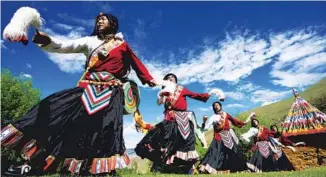  ?? ZHAN YAN / XINHUA ?? Farmers in the township of Lhayul in Chonggyai county, Tibet, dance to entertain tourists. Thanks to its improving environmen­t, Tibet has become an increasing­ly attractive tourist destinatio­n.