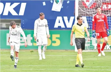  ??  ?? (FromL) Real Madrid's Spanish midfielder Daniel Ceballos, Real Madrid's Spanish defender Sergio Ramos and Real Madrid's Belgian goalkeeper Thibaut Courtois react after Eibar´s Spanish forward Kike Garcia scored during the Spanish league football match between SD Eibar and Real Madrid CF at the Ipurua stadium in Eibar. - AFP photo