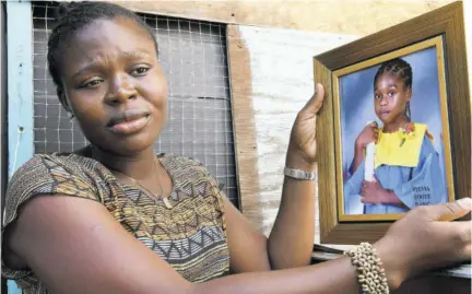  ?? (Photo: Naphtali Junior) ?? Japhene Campbell displays a photo of her son, Benjamin Bair, during an interview with the Jamaica Observer a day after the seven-year-old was crushed to death by a truck in a freak accident at his school, Clan Carthy Primary, on October 28, 2019.