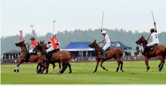  ??  ?? UAE Polo Team rides to victory (above) against Australia’s Scone Polo Club in Windsor Great Park to lift the cup, watched by fans including designer
new mum Jade Holland Cooper, looking stunning in Elie Saab (below)