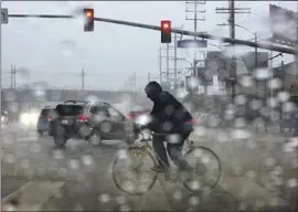  ?? Genaro Molina Los Angeles Times ?? A BICYCLIST riding in Culver City on Tuesday. One person was killed and two people were missing in Ontario as rain pounded Southern California.