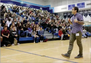  ?? Nikolas Samuels/The Signal (See additional photos at signalscv.com) ?? North Carolina State University student Pablo Campos speaks to a gym full of students at Saugus High School on Friday about his struggles with mental health and breaking the stigma of suicide.