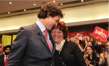  ?? JONATHAN HAYWARD/THE CANADIAN PRESS ?? Liberal leadership candidate Justin Trudeau hugs his mother, Margaret, on Wednesday at an event in Richmond, B.C., on his first day of campaignin­g.