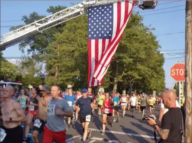  ?? BOB KEELER — MEDIANEWS GROUP ?? Runners take off at the start of the Moyer Indoor/Outdoor 5K in Souderton July 10. About 800 participan­ts took part in the race or its accompanyi­ng Kids Run.