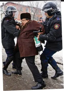  ??  ?? Crackdown: Kazakhstan police grapple with a man protesting about the massacre at Zhanaozen