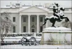  ?? ALEX BRANDON — THE ASSOCIATED PRESS ?? Snow blankets a statue of Andrew Jackson in Lafayette Square with the White House behind, as a winter storm arrives in the region, Sunday in Washington.