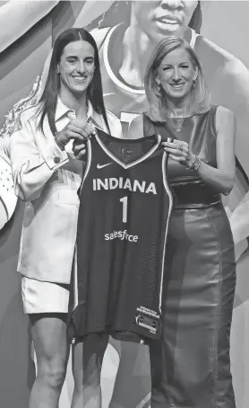  ?? BRAD PENNER/USA TODAY SPORTS ?? Caitlin Clark poses with WNBA commission­er Cathy Engelbert after being selected by the Fever with the No. 1 pick in the WNBA draft.