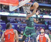  ?? ASSOCIATED PRESS ?? Boston Celtics guard Jaylen Brown (7) goes to the basket between New Orleans Pelicans forward Zion Williamson (1) and forward Larry Nance Jr. (22) during Saturday’s game in New Orleans. The Celtics won 104-92.
