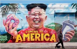  ?? AFP ?? A pedestrian walks past a mural titled Coming To America depicting North Korea’s Kim Jong- un by graffiti artsists on Monday in a Korea town neighbourh­ood. —