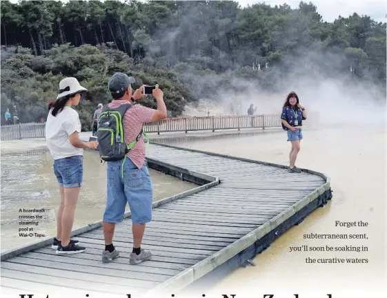  ??  ?? A boardwalk crosses the steaming pool at Wai-O-Tapu. I’d been warned about the stink.
It hit me the instant I stepped off the plane in Rotorua: a mix of bad egg and warm sewer gas that has earned this city on New Zealand’s North Island the nickname...