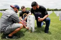  ??  ?? Marines Robert Campos, from right, Arturo Rocha and Jeremy Lara visit deceased comrade Cpl. Joseph E. Fite.