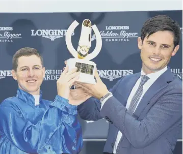  ?? PICTURE: JASON MCCAWLEY/GETTY ?? 0 Jockey Damian Lane, left, and trainer James Cummings with the Golden Slipper at Rosehill Gardens after Kiamichi’s surprise triumph in the big race last year.