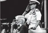  ?? AUDREY MCAVOY/AP ?? Everett Hyland, seated, who survived the attack, salutes along with his granddaugh­ter, Navy Cmdr. Anna-Marie Fine, during Friday’s remembranc­e at Pearl Harbor.