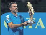  ?? ?? Roberto Bautista Agut lifts the 2022 ATP Qatar Open trophy, Doha, Qatar, Feb. 19, 2022.