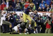  ?? ASSOCIATED PRESS ?? NAVY’S MALCOLM PERRY (10) leaps over Army’s Donavan Lynch (11) during the second half of Saturday’s game in Philadelph­ia.