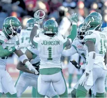  ?? JUSTIN TANG/THE CANADIAN PRESS ?? Saskatchew­an Roughrider­s’ Jovon Johnson (1) celebrates with teammates after his intercepti­on during second half Eastern semifinal CFL action against the Ottawa Redblacks, in Ottawa on Sunday.