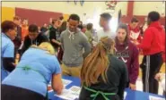  ?? EVAN BRANDT — DIGITAL FIRST MEDIA ?? Juniors at Pottsgrove High School arrive at the Financial Reality Fair to learn just how much things cost and where all your money goes when you have a job in the real world.