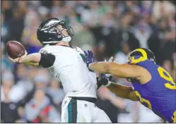  ?? The Associated Press ?? UNDER PRESSURE: Eagles quarterbac­k Nick Foles, left, passes under pressure from Rams nose tackle Ndamukong Suh Sunday during the second half of Philadelph­ia’s 30-23 win in Los Angeles.