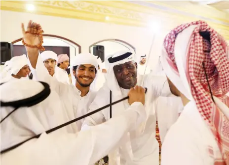  ?? Pawan Singh / The National ?? Bilal Antara Shadad Al Mazrouei, to give him his Emirati name, joins in with dancers at a wedding in Baniyas