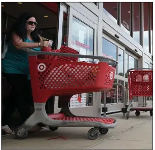  ?? (Arkansas Democrat-Gazette/Stephen Swofford) ?? Sher Baltz exits the Target store on Chenal Parkway in Little Rock on Friday. Even with the sales declines, the pandemic is forcing shifts in what people buy, with pajama-buying reported to go up 143% from March to April.