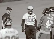  ??  ?? Atlanta’s Joe Vellano (92) works out with teammates under the watch of head coach Dan Quinn at the football team’s practice facility in Flowery Branch.