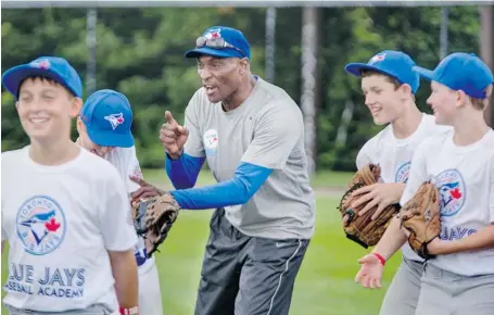  ?? CHRIS MIKULA/OTTAWA CITIZEN ?? Former Blue Jays outfielder Lloyd Moseby works with outfielder­s aged nine to 16 as part of a Toronto Blue Jays instructio­nal clinic at Kinsmen Field baseball park in Kanata on Thursday.