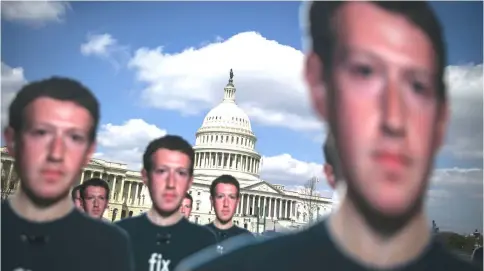  ??  ?? Cutouts of Zuckerberg’s are displayed near the Capitol in Washington, D.C., on Apr 10.