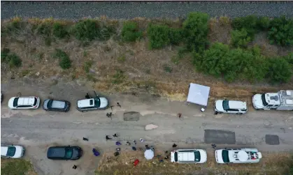  ?? Photograph: Anadolu Agency/Getty Images ?? More than 50 people were found dead inside a tractor-trailer that was abandoned on the outskirts of San Antonio, Texas, on Monday.