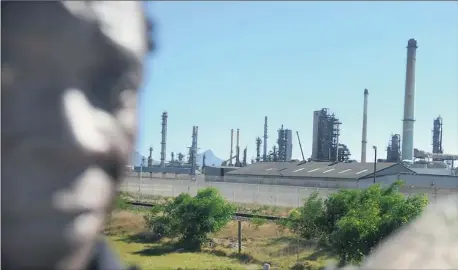  ?? Picture: JEFFREY ABRAHAMS ?? SCENE SETTER: The Chevron oil refinery in Milnerton has been cordoned off while authoritie­s investigat­e a flash fire in which a man died and another was injured. Petersen Visam is seen here walking past the refinery.