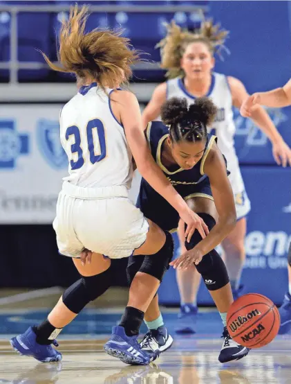  ?? MARK ZALESKI / FOR THE TENNESSEAN ?? Arlington guard Christina Nichols (14) and Brentwood center Sophie Roston (30) scramble for the ball during the first half of a Class AAA state quarterfinal on March 11.