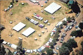  ?? Ap-noah Berger ?? In this aerial photo, vendor booths line Christmas Hill Park, in Gilroy, Calif., the site of a shooting the day before at the Gilroy Garlic Festival. Authoritie­s on Monday were searching for answers to why a 19-year-old opened fire on a popular food festival less than a mile from his parents’ home in California, killing two children and another man, but believe many more people would have died if officers patrolling the event had not stopped the gunman so quickly.