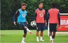  ?? AFP ?? Neymar and Brazil midfielder Philippe Coutinho (centre) take part in a training session at Anfield, north-east of London.