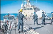  ?? SPECIALIST 2ND CLASS DANIELLE BAKER — U.S. NAVY VIA NYT ?? Sailors work on the combat ship USS Milwaukee as it arrives in Guantanamo Bay, Cuba, on Monday.