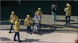  ?? ABC7 LOS ANGELES VIA AP ?? In an aerial image taken from video, emergency personnel take a person out of the Encino Hospital Medical Center where a suspect stabbed multiple people Friday and barricaded himself in the hospital.