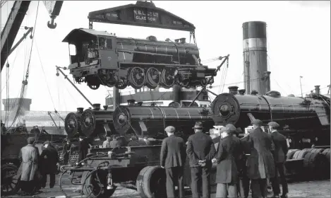  ??  ?? „ An impressive sight as a locomotive built at St Rollox is loaded on to a liner at Stobcross Quay for shipment to Bombay in 1933.